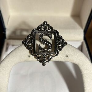 Silver letter S brooch.